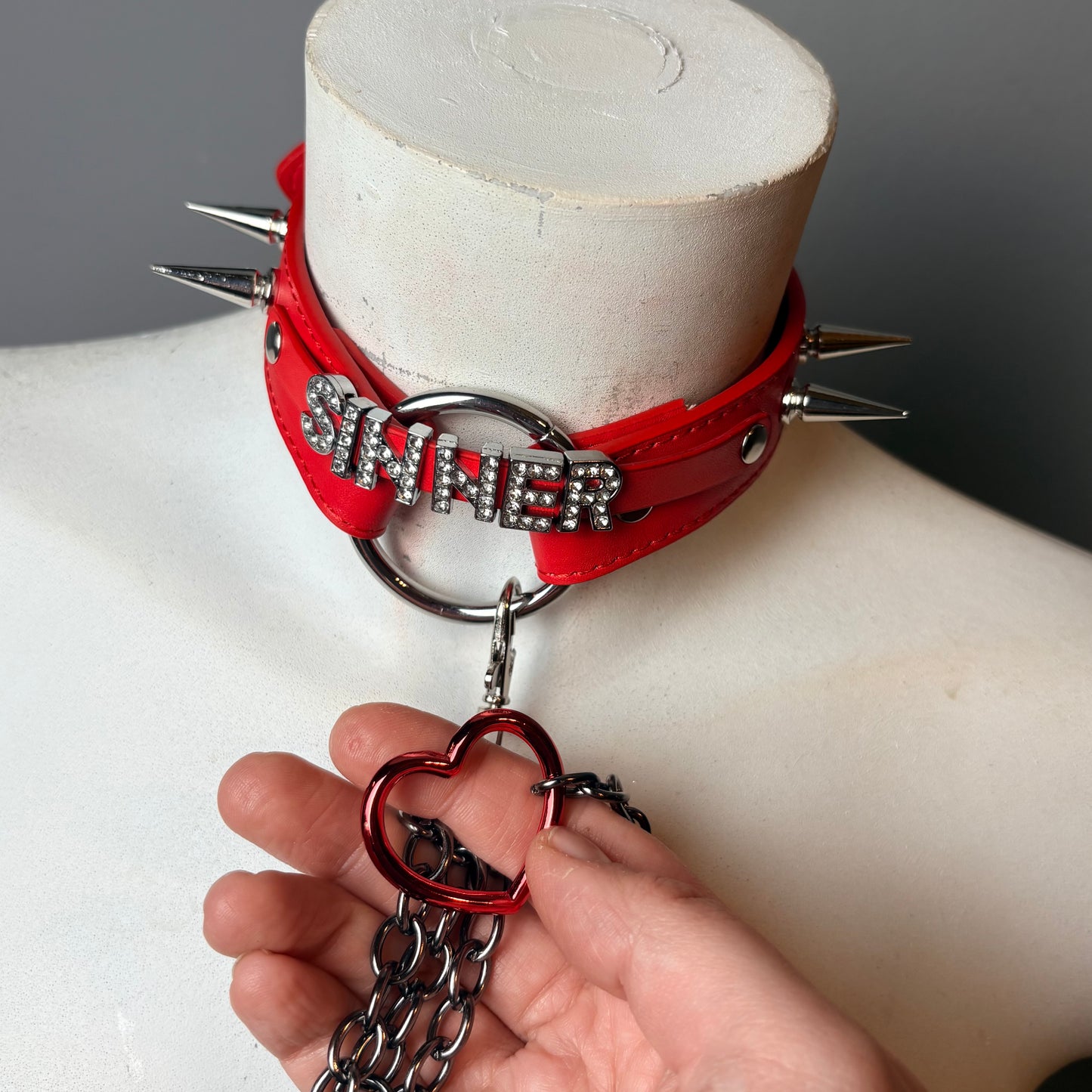 Chocker rosso con scritta “sinner”